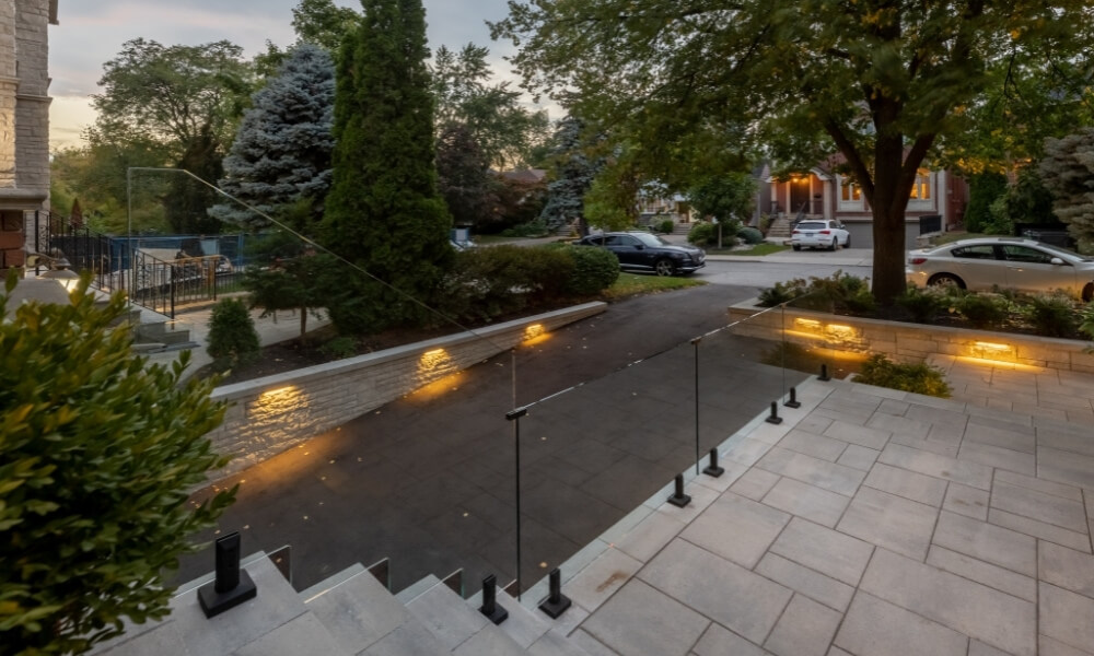 custom retaining wall toronto with glass railings lighting