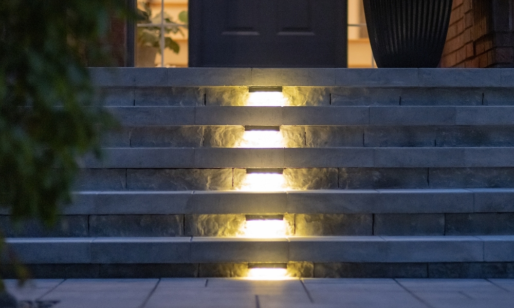 custom retaining wall with glass railings lighting toronto