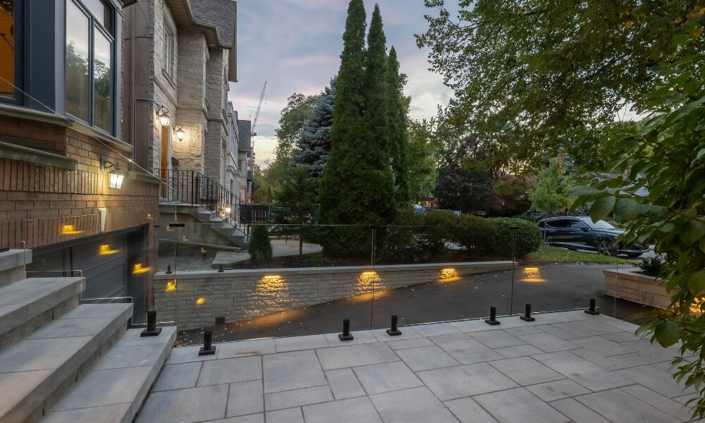 custom toronto retaining wall with glass railings lighting