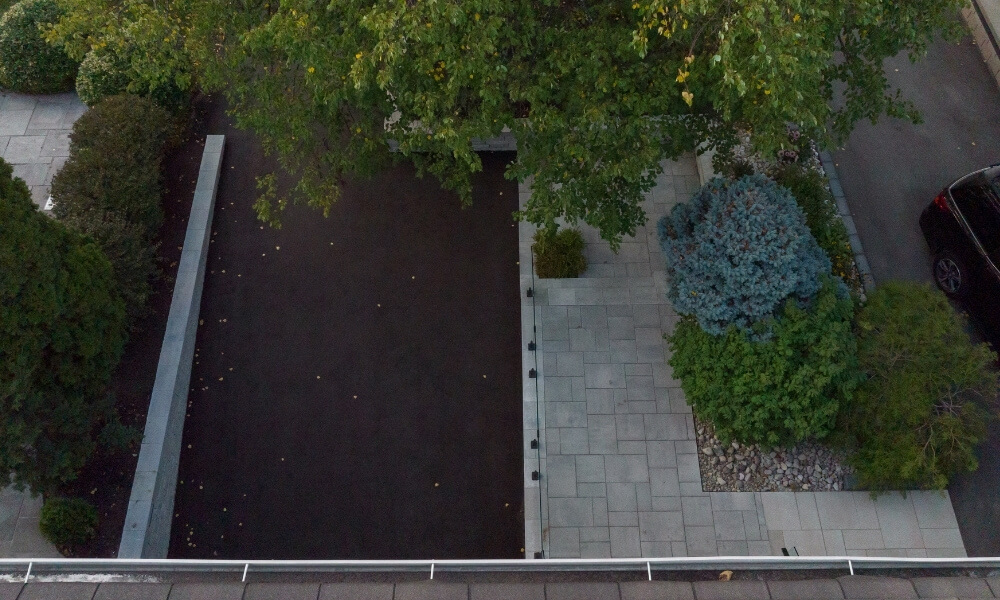 custom retaining wall with glass railings lighting